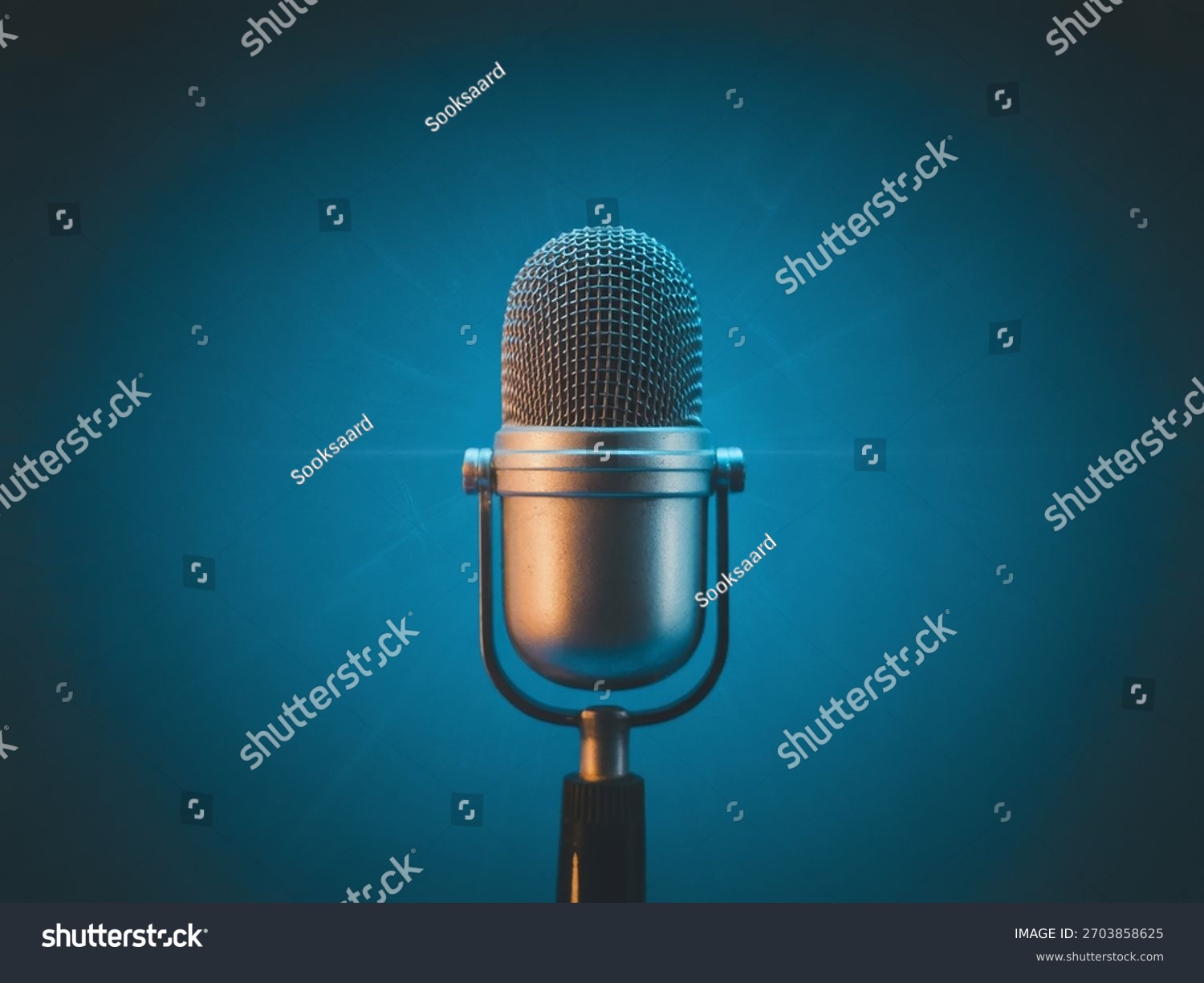 stock-photo-retro-silver-microphone-on-blue-background-with-dramatic-studio-lighting-for-podcast-music-and-2703858625